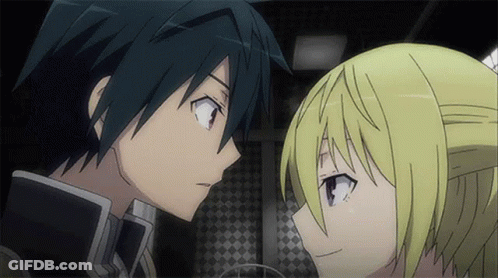 A Boy And A Girl Are Looking At Each Other In A Dark Room GIF