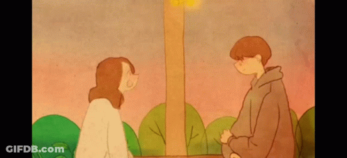 A Boy And A Girl Are Looking At Each Other In A Park . GIF