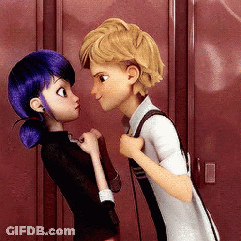 A Boy And A Girl Are Looking At Each Other In Front Of Red Lockers GIF