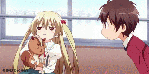 A Boy And A Girl Are Looking At Each Other While The Girl Is Holding A Stuffed Squirrel . GIF
