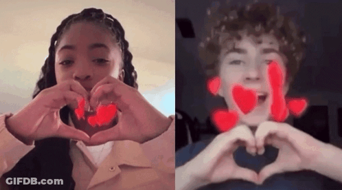 A Boy And A Girl Are Making A Heart Shape With Their Hands GIF