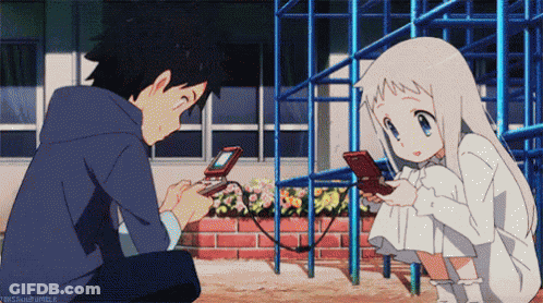 A Boy And A Girl Are Playing A Video Game And The Girl Is Looking At Her Phone GIF