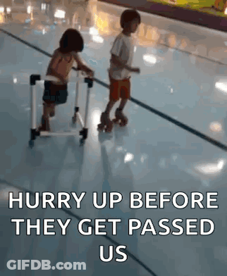 A Boy And A Girl Are Rollerblading On A Rink And The Girl Is Sitting On A Walker . GIF