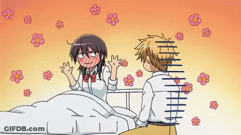 A Boy And A Girl Are Sitting Next To Each Other On A Bed With Flowers Flying Around Them . GIF