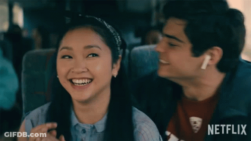 A Boy And A Girl Are Sitting Next To Each Other On A Bus With Netflix Written On The Bottom GIF