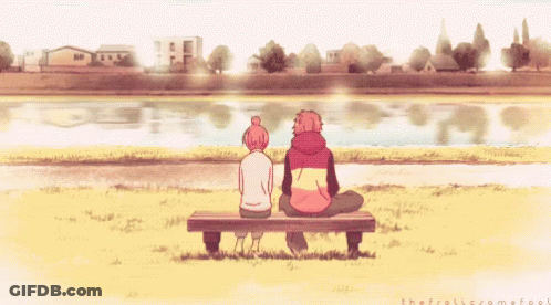 A Boy And A Girl Are Sitting On A Bench Looking At A Body Of Water GIF