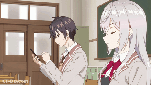 A Boy And A Girl Are Standing In A Classroom Looking At A Cell Phone GIF