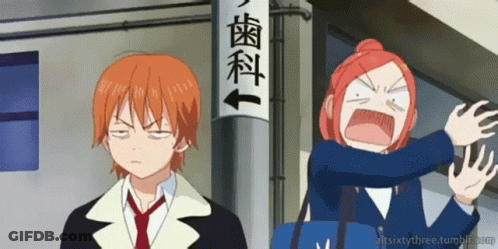 A Boy And A Girl Are Standing In Front Of A Sign That Says ' Dental ' GIF