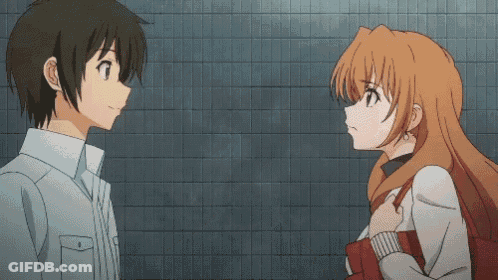 A Boy And A Girl Are Standing Next To Each Other And The Boy Is Pointing At The Girl GIF