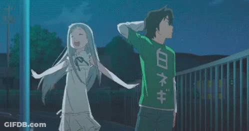 A Boy And A Girl Are Standing Next To Each Other And The Boy Is Wearing A Green Shirt With Chinese Writing On The Back GIF