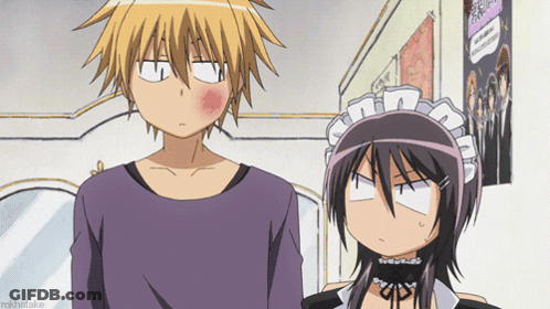 A Boy And A Girl Are Standing Next To Each Other And The Girl Has A Red Cheek GIF