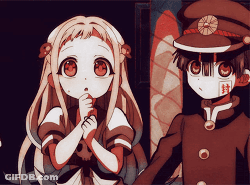 A Boy And A Girl Are Standing Next To Each Other And The Girl Has A Skull In Her Hair GIF