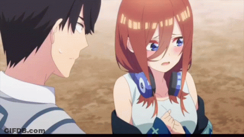 A Boy And A Girl Are Standing Next To Each Other And The Girl Has Headphones On Her Head GIF