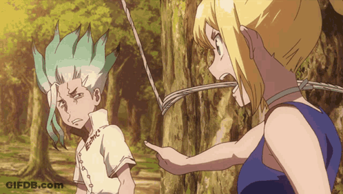 A Boy And A Girl Are Standing Next To Each Other And The Girl Is Pointing GIF