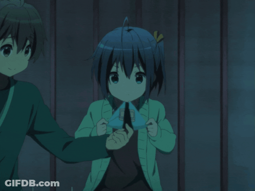 A Boy And A Girl Are Standing Next To Each Other And The Girl Is Wearing A Green Sweater GIF