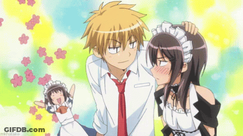 A Boy And A Girl Are Standing Next To Each Other And The Girl Is Wearing A Maid Costume . GIF