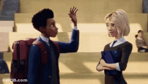 A Boy And A Girl Are Standing Next To Each Other In A Classroom . The Boy Is Waving At The Girl . GIF