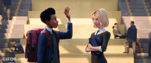 A Boy And A Girl Are Standing Next To Each Other In A Crowded Stadium GIF