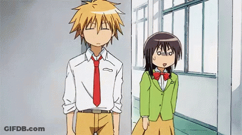 A Boy And A Girl Are Standing Next To Each Other In A Hallway . The Girl Is Wearing A Green Jacket . GIF