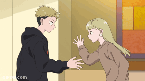 A Boy And A Girl Are Standing Next To Each Other In A Room GIF
