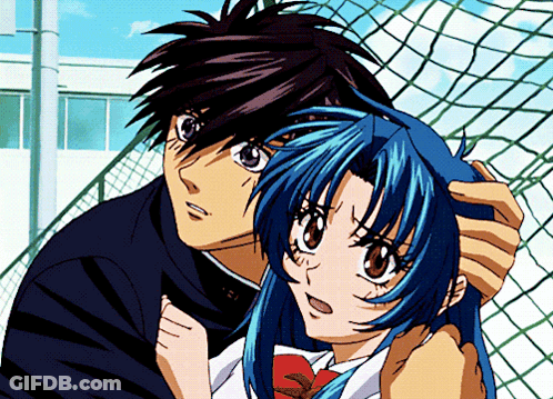 A Boy And A Girl Are Standing Next To Each Other In Front Of A Fence GIF