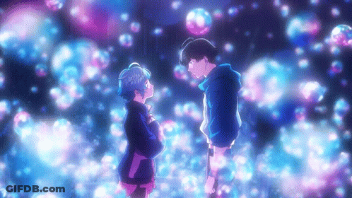 A Boy And A Girl Are Standing Next To Each Other In Front Of Bubbles GIF
