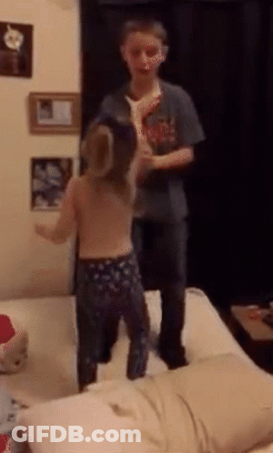 A Boy And A Girl Are Standing On A Bed GIF