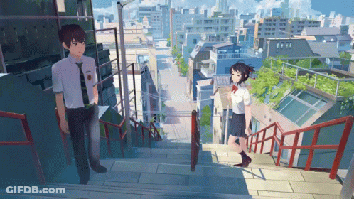 A Boy And A Girl Are Standing On A Set Of Stairs In A City GIF