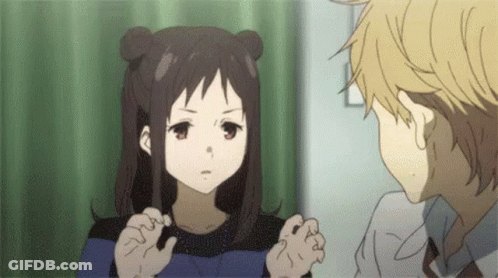 A Boy And A Girl Are Talking To Each Other In A Room . The Girl Is Looking At The Boy . GIF