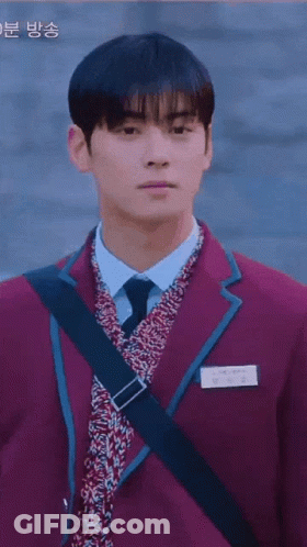 A Boy And A Girl Are Walking Down A Street . GIF