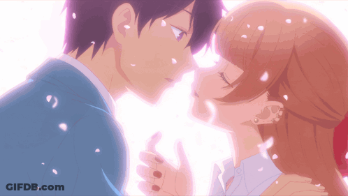A Boy And A Girl Kissing With Petals Falling Around Them GIF