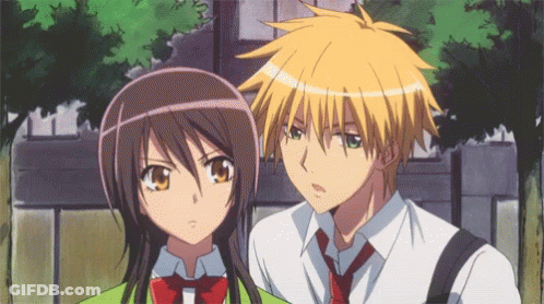 A Boy And A Girl Standing Next To Each Other GIF
