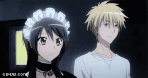 A Boy And A Girl Standing Next To Each Other GIF