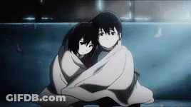 A Boy And A Girl Wrapped In A Blanket Are Hugging Each Other . GIF
