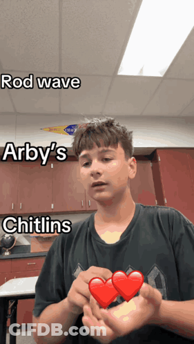 A Boy Holding A Heart With The Words Rod Wave Arby 'S And Chitlins Written On It GIF