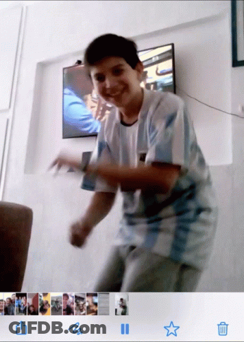 A Boy In A Argentina Shirt Is Dancing In Front Of A Television GIF