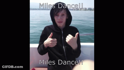 A Boy In A Black Hoodie Giving A Thumbs Up With The Words Miles Dance GIF