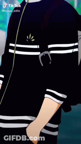 A Boy In A Black Jacket Is Smoking A Cigarette While Standing On A Street . GIF
