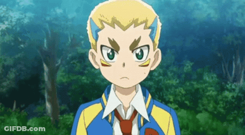 A Boy In A Blue And Yellow Jacket And Tie Is Standing In Front Of Trees . GIF