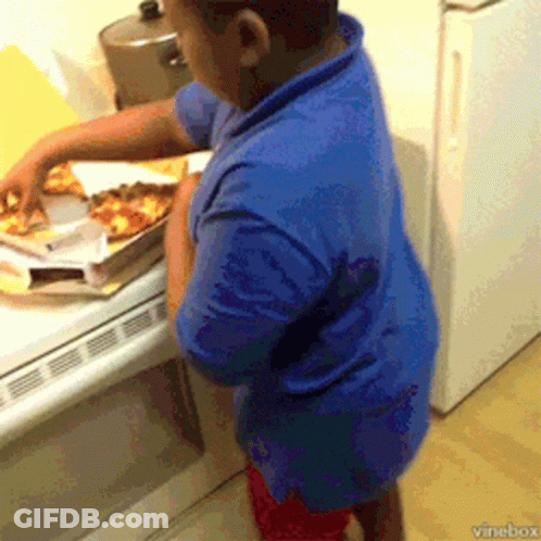 A Boy In A Blue Shirt Is Taking A Slice Of Pizza From A Box GIF