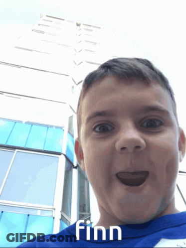 A Boy In A Blue Shirt With Finn Written On It GIF