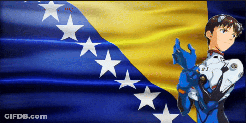 A Boy In A Blue Suit With The Number 01 On His Chest Stands In Front Of A Yellow And Blue Flag GIF