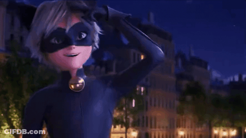 A Boy In A Cat Noir Costume Is Waving At The Camera . GIF