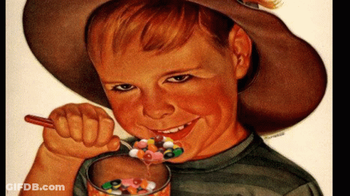 A Boy In A Cowboy Hat Is Eating Cereal With A Spoon And Smiling GIF