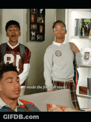 A Boy In A Football Jersey Says " I Made The Football Team " Next To A Girl GIF