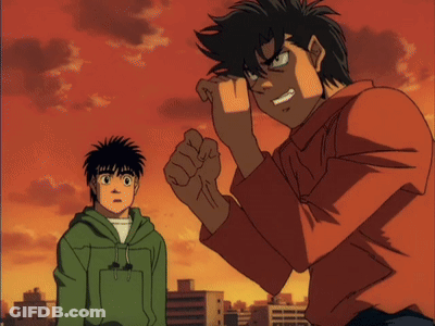 A Boy In A Green Hoodie Stands Next To A Man In A Red Shirt GIF