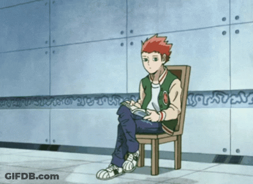 A Boy In A Green Jacket Sits In A Chair With His Legs Crossed While Reading A Book GIF