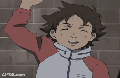 A Boy In A Red And White Jacket Is Smiling With His Hand In The Air GIF