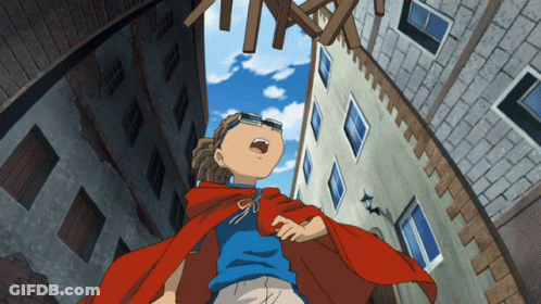 A Boy In A Red Cape And A Blue Shirt Is Looking Up At Something GIF