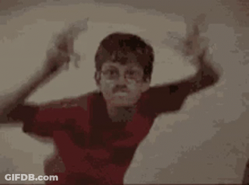A Boy In A Red Shirt And A Boy In A Black Tank Top Are Standing Next To Each Other . GIF
